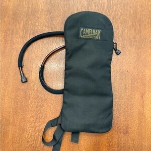DADS ESTATE SALE: Never used Camelbak with bladder, about 17” x 7”.